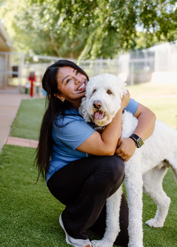 Happy employee hugging a dog